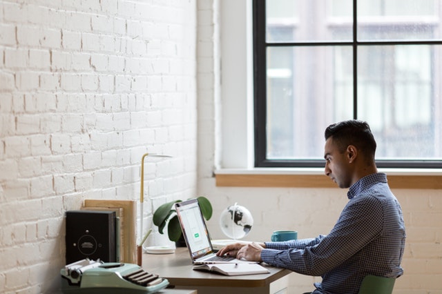 A Virtua Assistant creating his final draft in his laptop